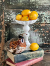The Latisha White Distressed Metal Pedestal Candle Stand